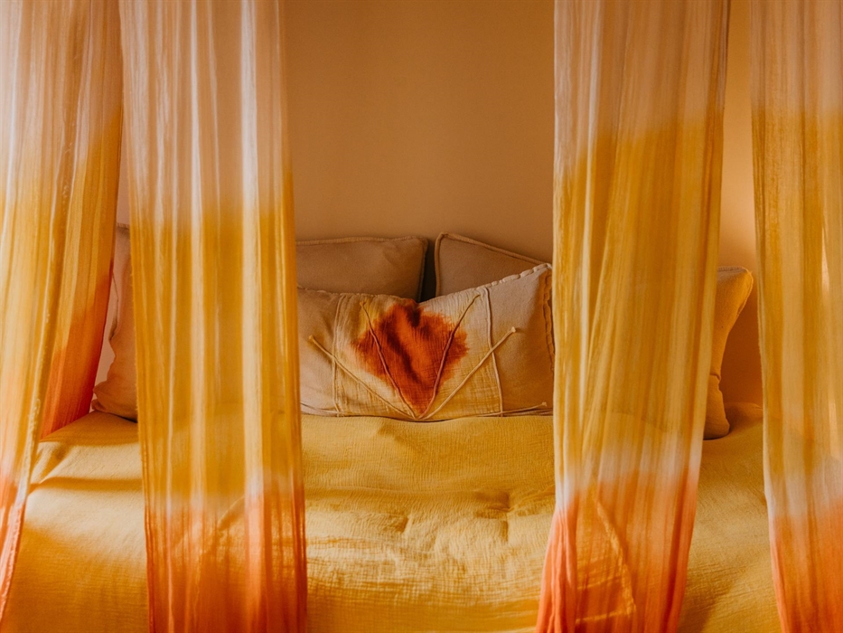 The Dawn is south facing with a balcony view of the Elemental Garden and the Nant Caethon Valley. The handmade soft furnishings were created using nat