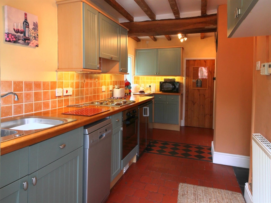 Gallery style kitchen with full range of appliances