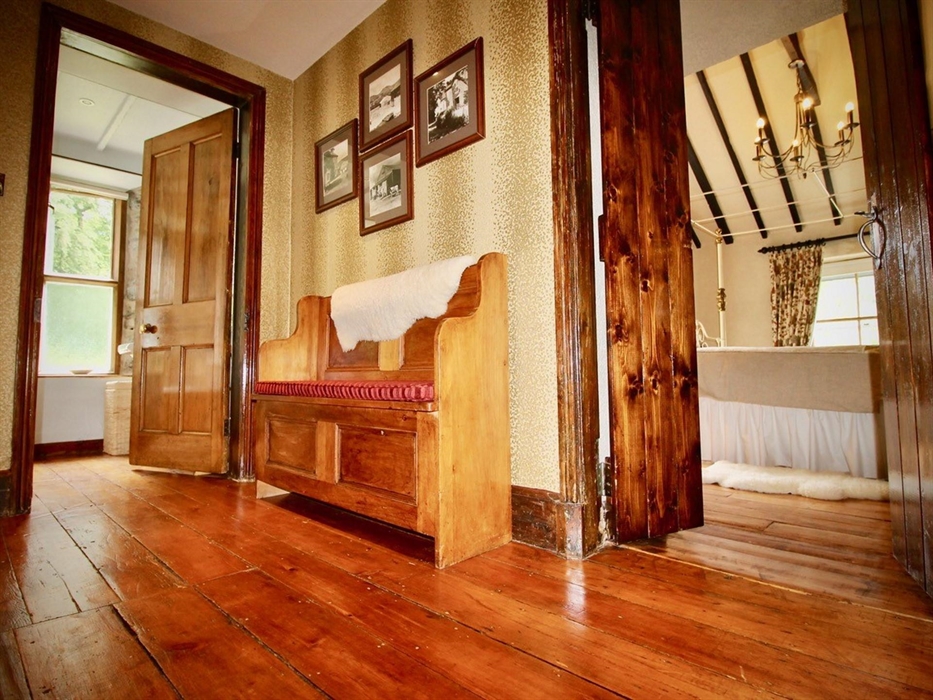 Landing with original wooden floors, leading into master bedroom, shower room, twin room. storage cupboard on landing