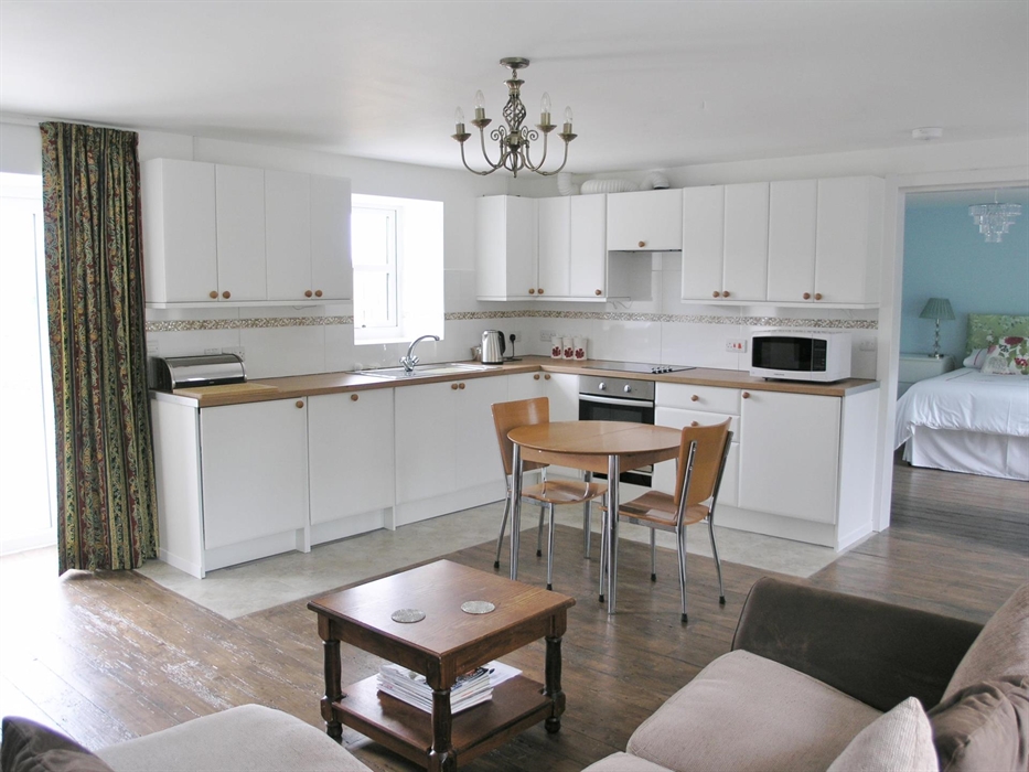 Compact yet well equipped kitchen including dishwasher and washing/tumble drying machine.