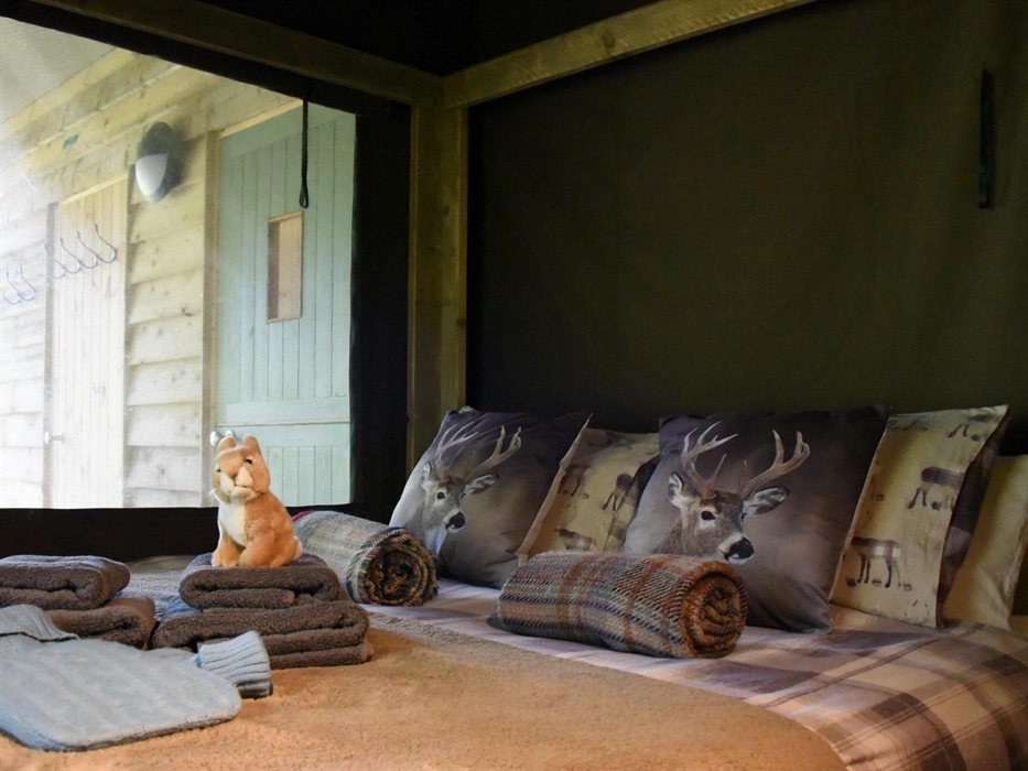 Comfortable four poster bed in a private bedroom
