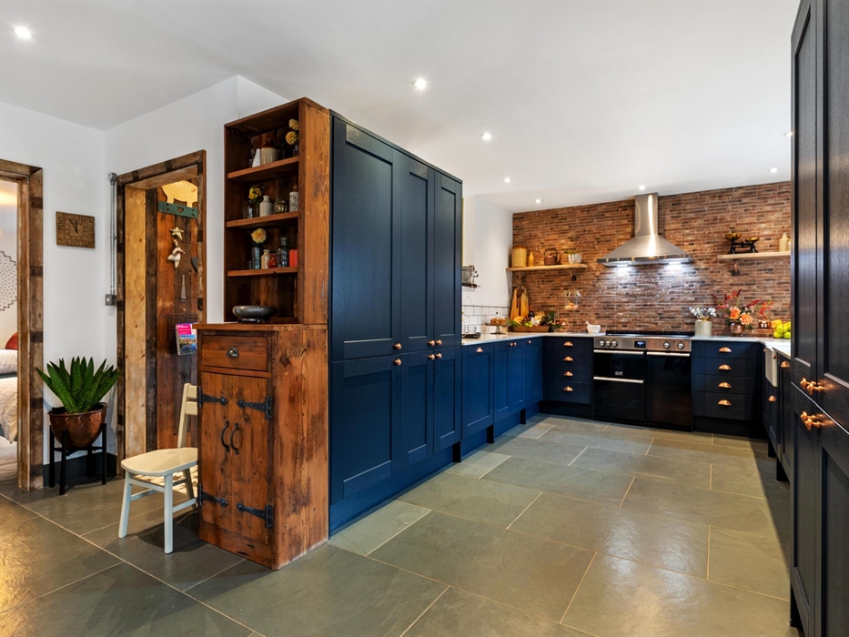 ample storage cupboards, reclaimed handmade wooden cupboard, slate flooring with underfloor heating