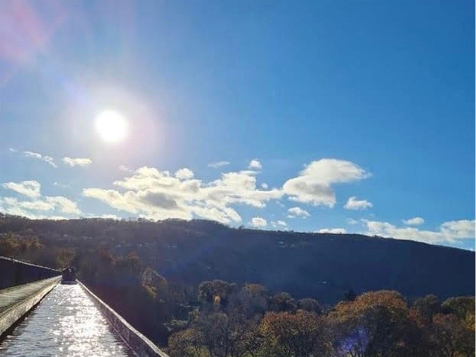 A view of the beautiful tree tops and the blue sky sunny sky from the iconic Pontcysyllte Aqueduct.