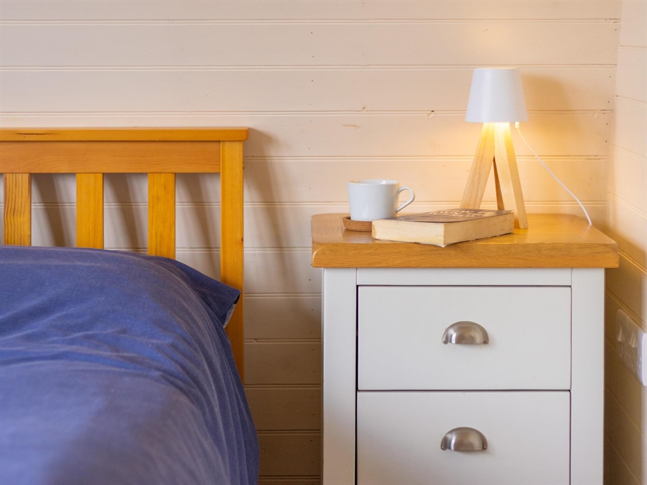 Lamp and book by bed