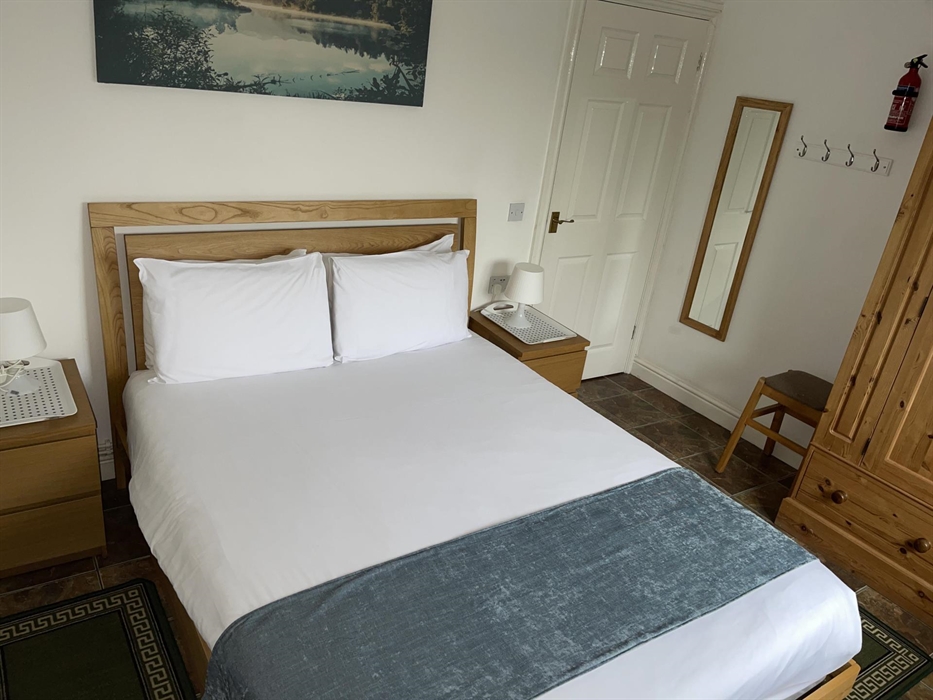 Shows positioning of pine wardrobe, king size bed, mirror, table lamps, and 2 bedside cabinets.