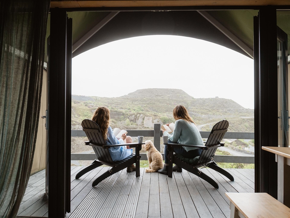 Enjoy a moment of peace on your private deck overlooking Llechwedd quarry, Zip World Llechwedd, and the mountains and valleys of Eryri (Snowdonia)