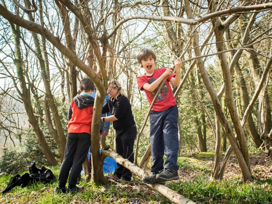 Boy balancing on branch bushcraft activity