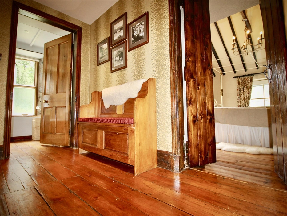The landing leading to the master bedroom with vaulted ceiling, the shower room and the twin bedroom