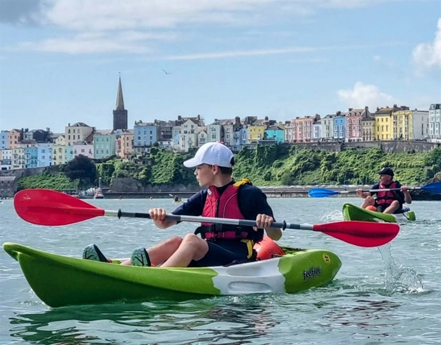 Kayaker with Tenby North Bay in the background