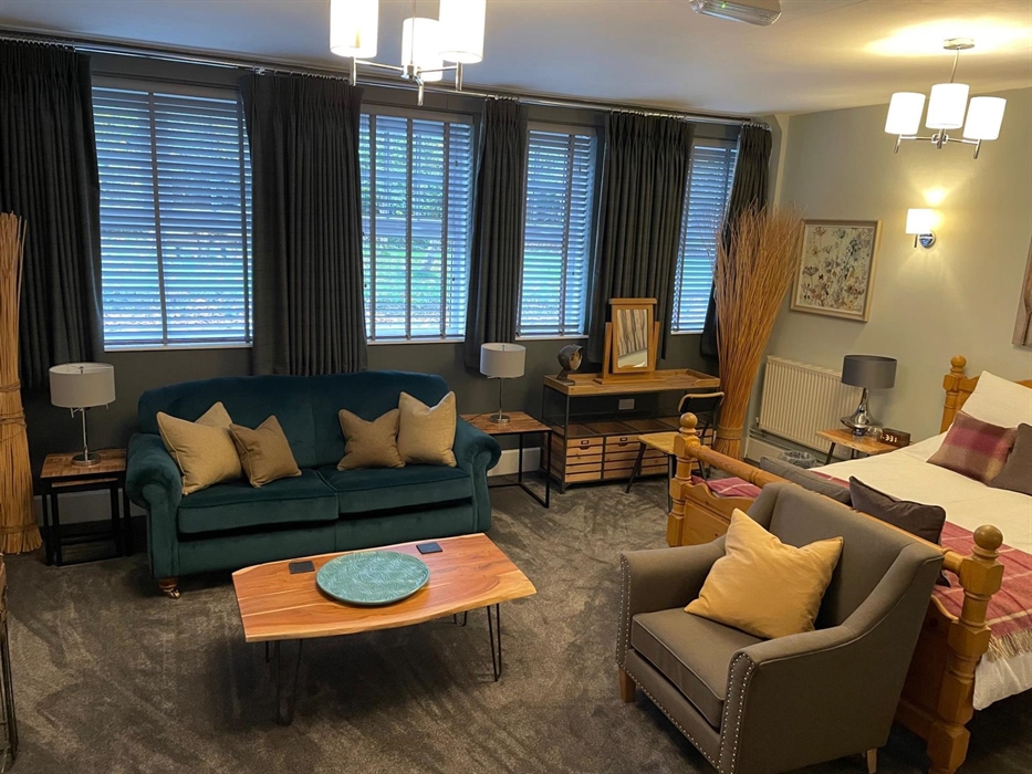 With a kingsize bed, sofa and chair in the room there are plenty of choices to relax.
There is a smart tv with all of the streaming channels availabl