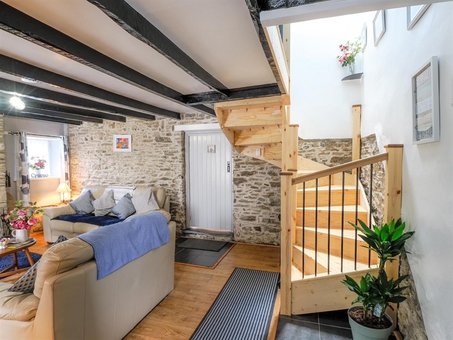 Living room with stairs leading to bedrooms