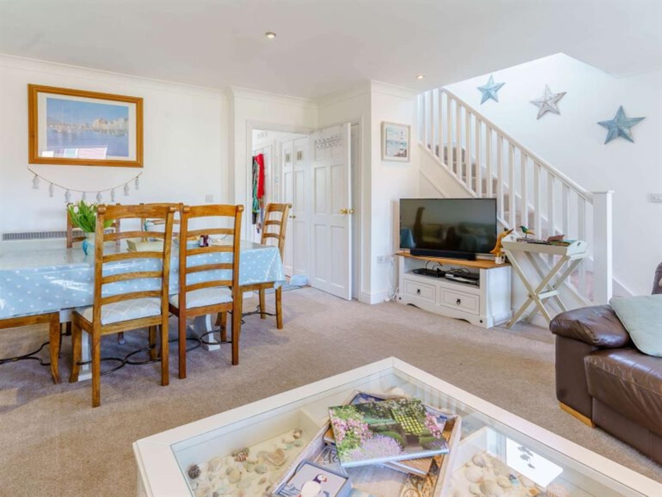 The view from the settees, the table seats 6 comfortably, the TV has surround sound, and also is a smart TV.  We like to see collections of shells in