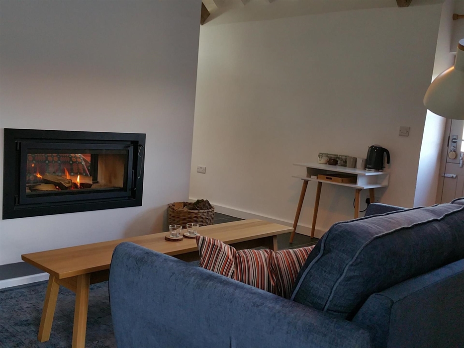 Sofa facing a coffee table and a 2 sided fireplace
