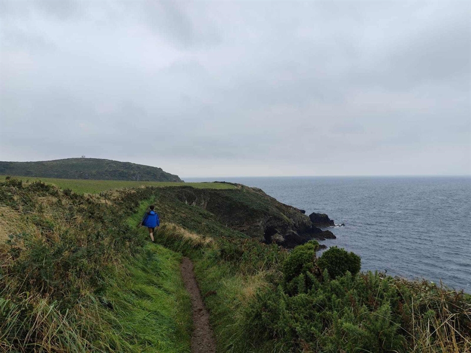 Walker on the coast path near to the cliff edge