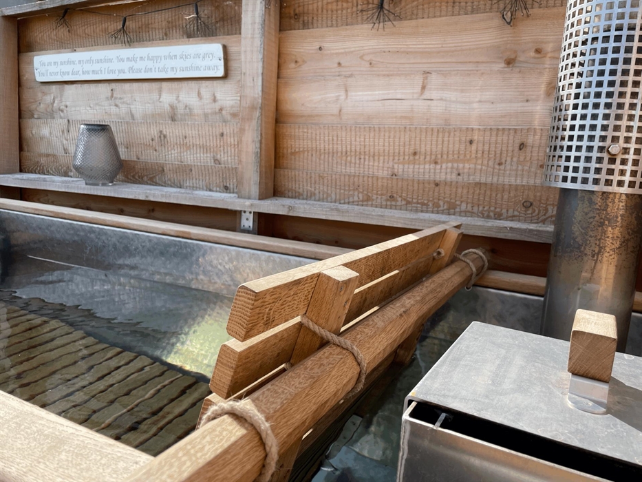 The wood fired hot tub filled with fresh water with the log burner ready to light