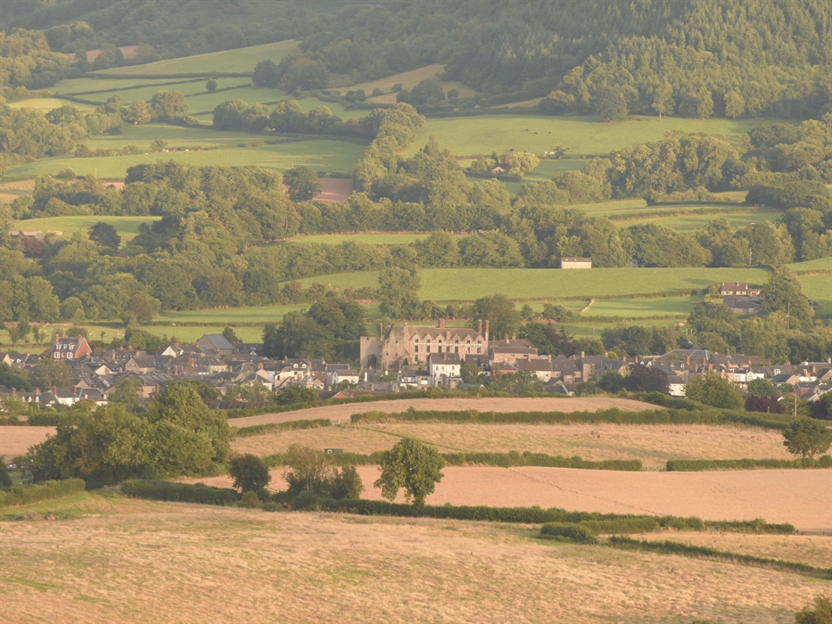 Hay Castle sits alongside the River Wye in front of the Black Mountains