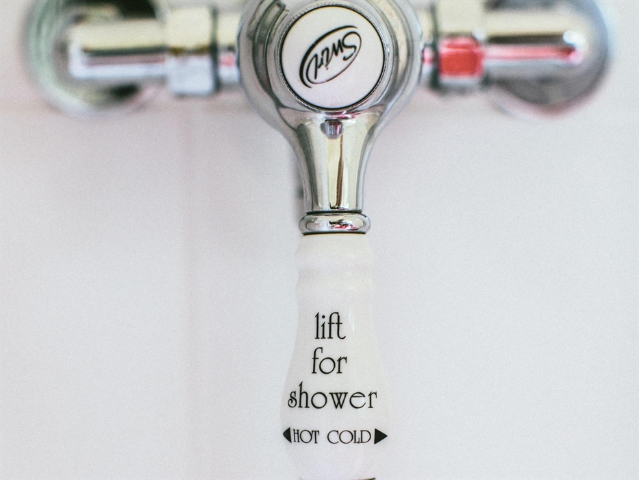 Victorian style hot and cold shower tap.