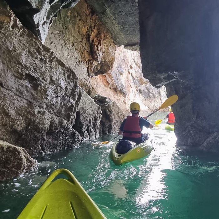 Kayakers exploring the Tenby caves