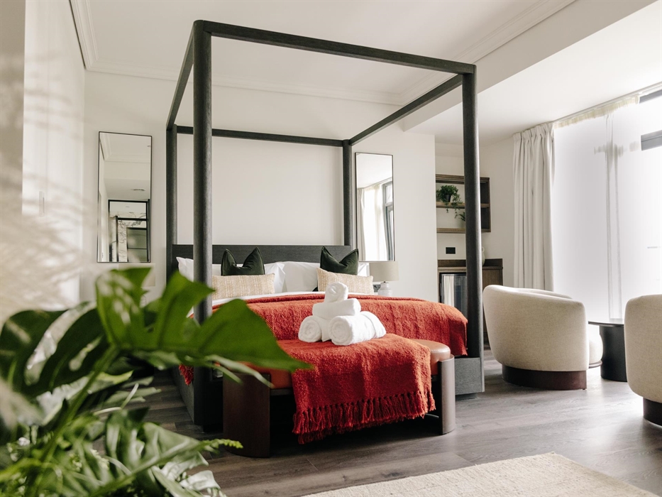 Introducing our spacious suite with a four-poster super king-sized bed, beautiful standalone bath, fireplace, and adjoining lounge.