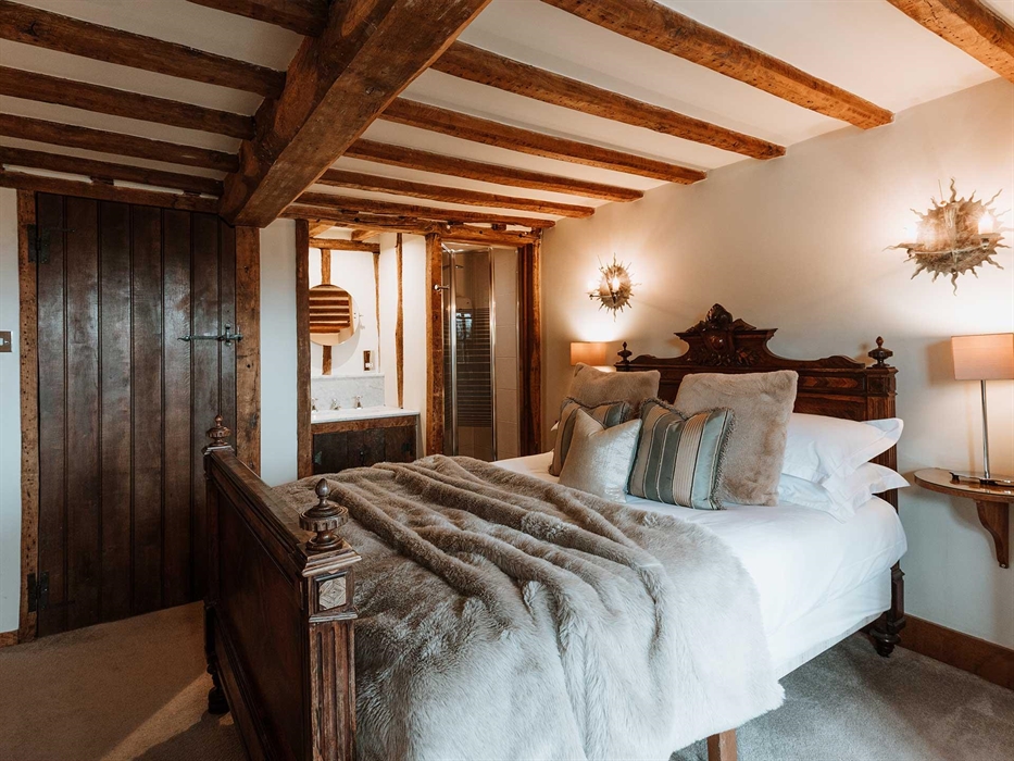 Bedroom Four is in the oldest part of the house going back to the late 17th century. The ceiling beams echo the age of the house and the bay window gi