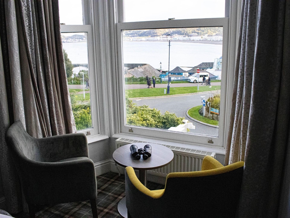 Unwind by the window with stunning sea views, cozy seating, and a perfect spot to watch the world go by. Binoculars included.