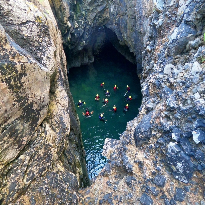 Coasteerers in a secret pool