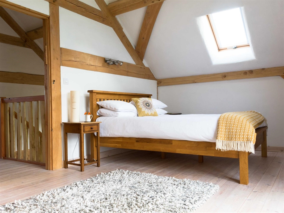 main bedroom upstairs with lounge area and balcony
