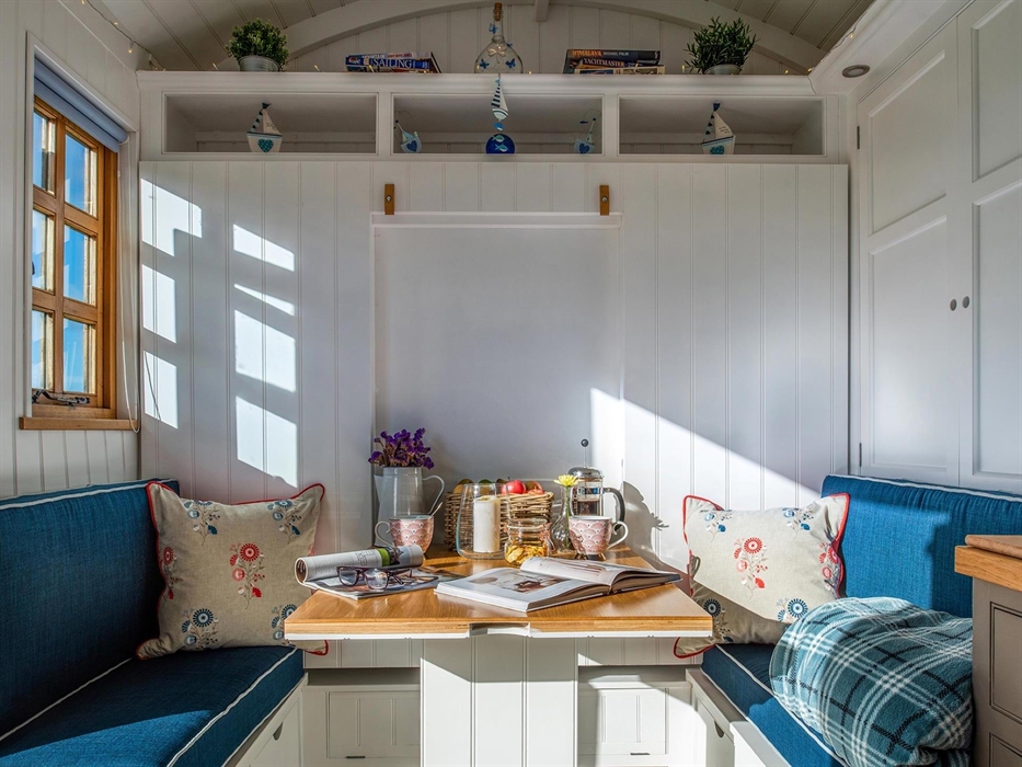 This area folds up and converts to a full size double bed.  On the right is a cleverly designed wardrobe. And there is lots of under-seat storage.