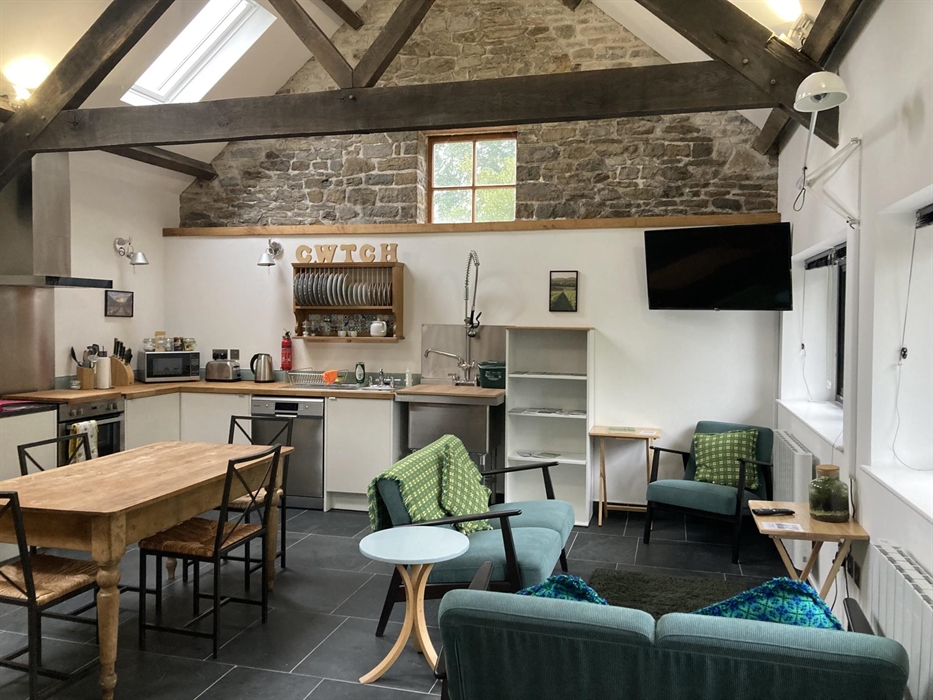 Comfy seating, dining table and well equipped, fitted kitchen.