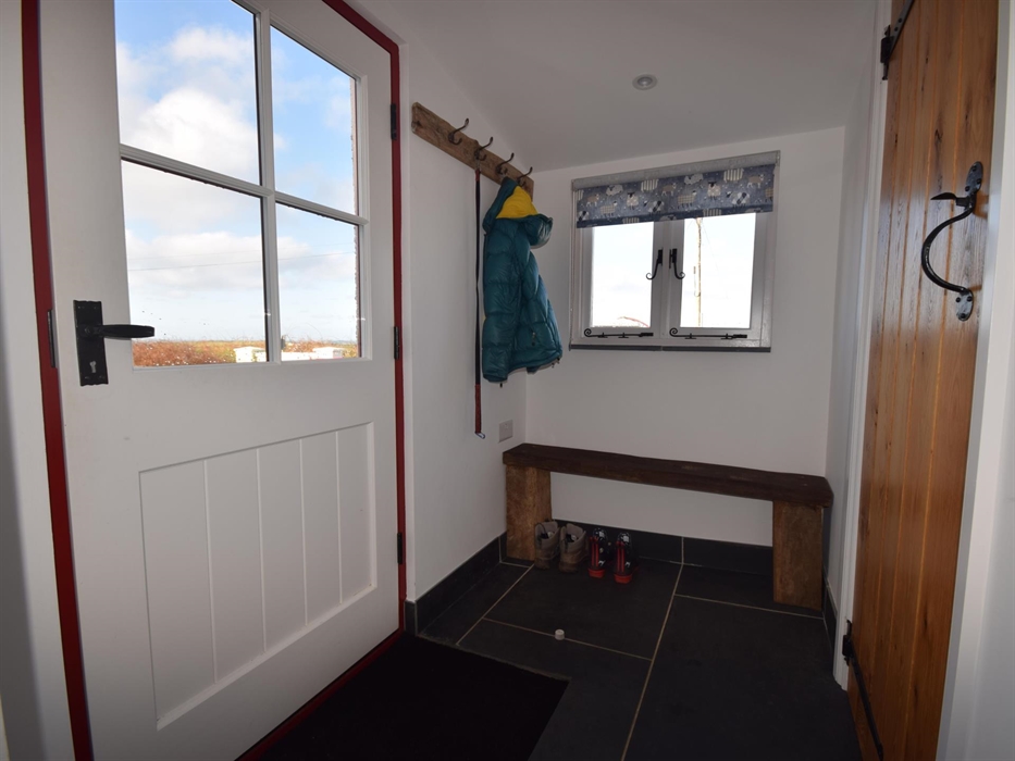 Space for coats & shoes/boots.
Door to WC on the right.