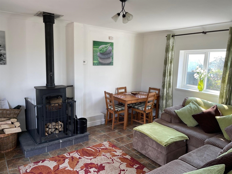 shows the corner sofa, rear window, table and 4 chairs and the Charnwood Cove multi-fuel fire
