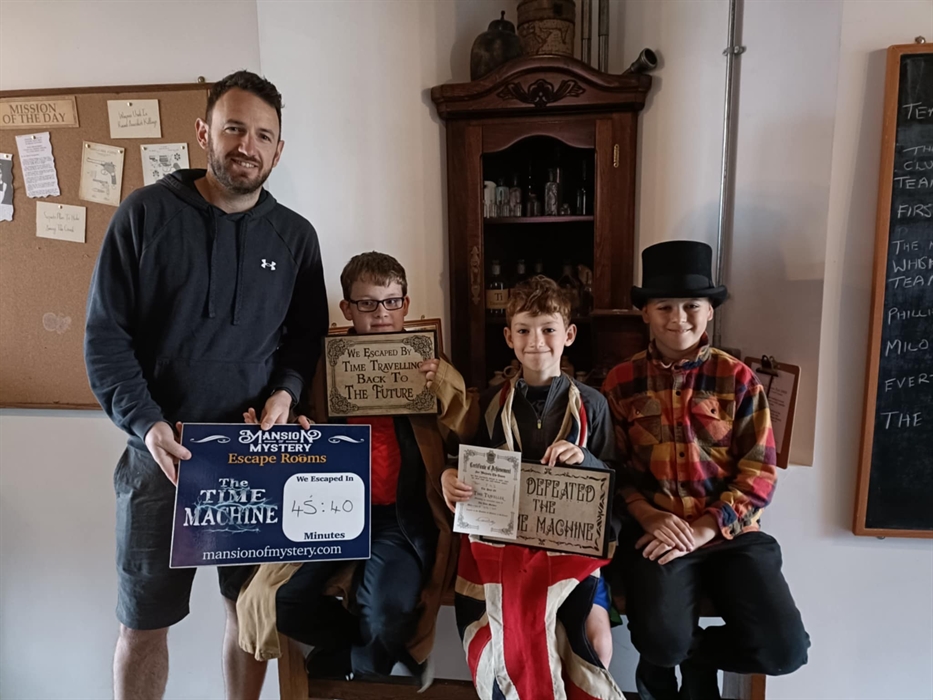 Group enjoying a fun indoor activity at Mansion of Mystery escape rooms in St.Clears.