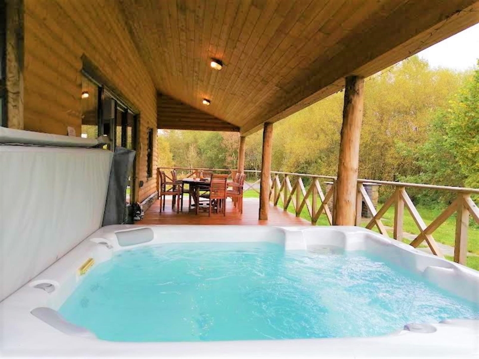 There is a hot tub on the veranda, which seats 8 people.  Under the veranda is a dining area and a BBQ is close by on the lawn.  At night the veranda