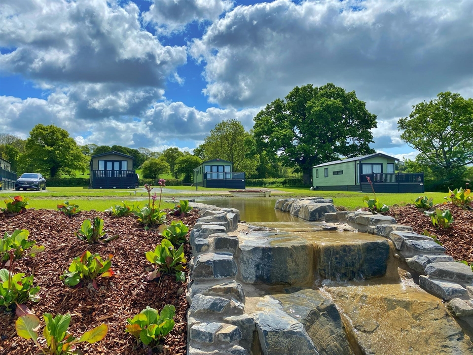 Caravans wrapped around two pools and waterfall