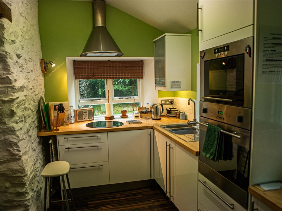 Hen Ffermdy cottage kitchen with oven, microwave hob, radio and essentials for cooking