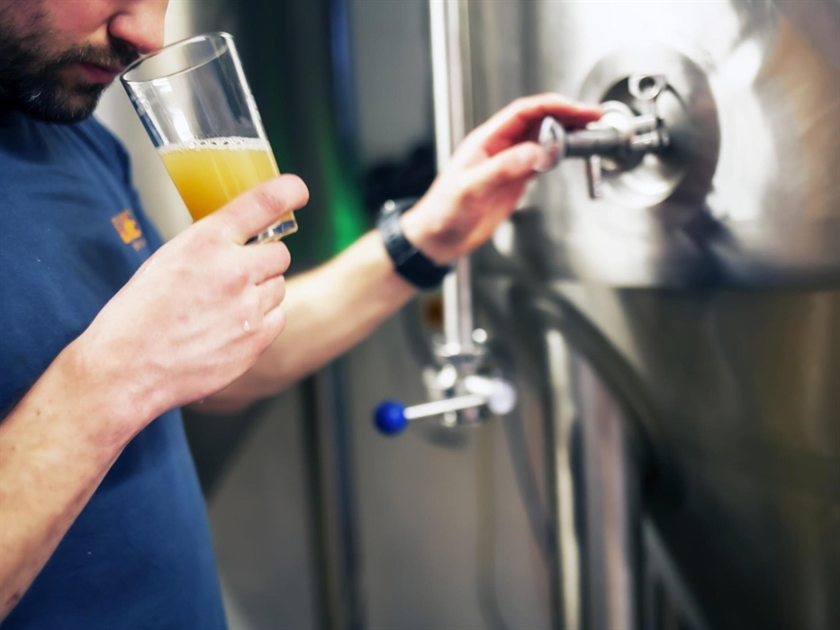 Our Brewer, Tom, sampling a beer before bottling.