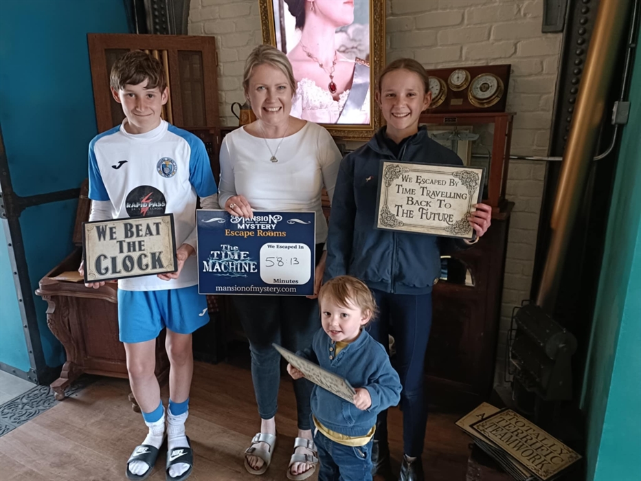 Family enjoying a fun escape room experience at Mansion of Mystery in St Clears, Carmarthenshire.