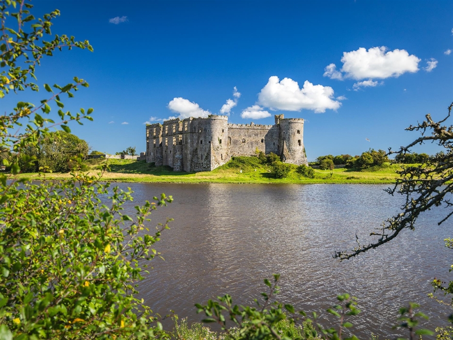 Image of Carew Castle at a different angle as well as the large pond.