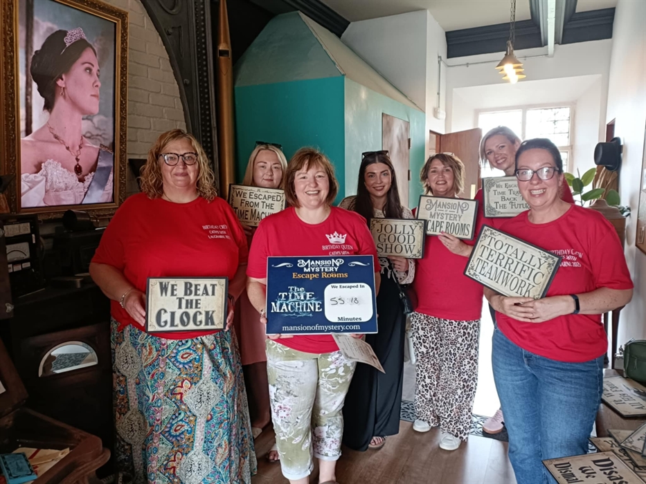 Friends working as a team in Mansion of Mystery escape rooms, West Wales.