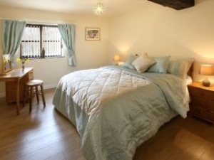 This bedroom is adjacent to the wet room so is often preferred by guests with disabilities.  Also, the bed will accommodate a hoist.