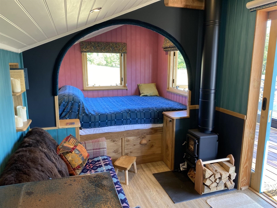 Handbuilt cabin with wood burning stove, ensuite bathroom and outdoor bath, super comfy king size bed, cozy sofa, sheepskin rugs and Welsh woolen blan