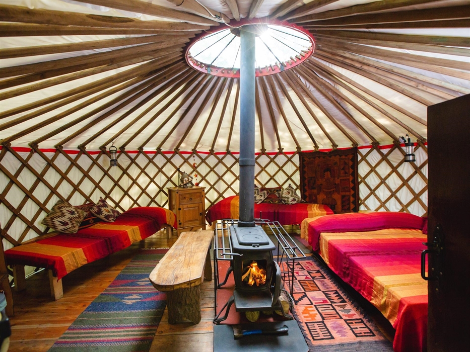 In its own private setting this is a very cosy and warm yurt with a central wood-burning stove, one double and two singles beds it sleeps 4 people.The