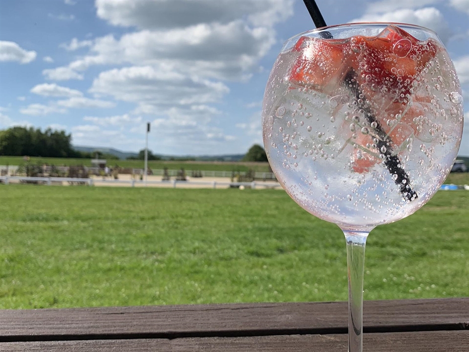 Enjoying all the Equestrian Action with a drink