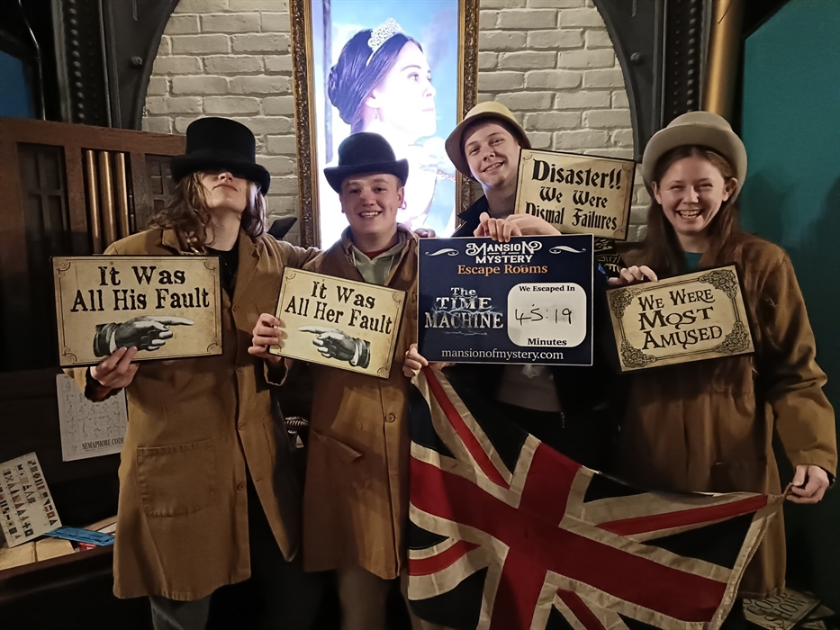 Friends solving puzzles at Mansion of Mystery escape rooms, St Clears West Wales.