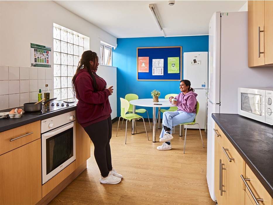 Students sitting in the kitchen area having a coffee