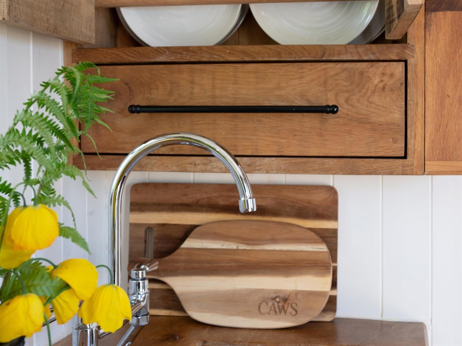 Induction hob and oven, cutlery, crockery, utensils, pots and pans. Small built-in fridge with freezer drawer for ice, SMEG Kettle, Coffee Plunger and