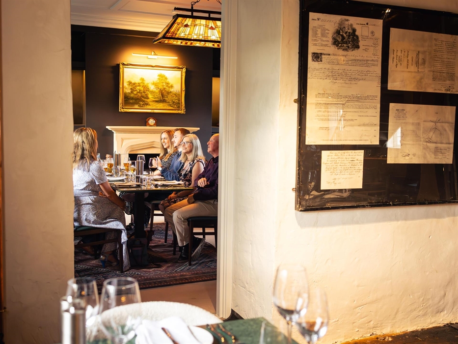 An image of a group of adults enjoying a team meal at the private dining rooms in Black Pool Mill.