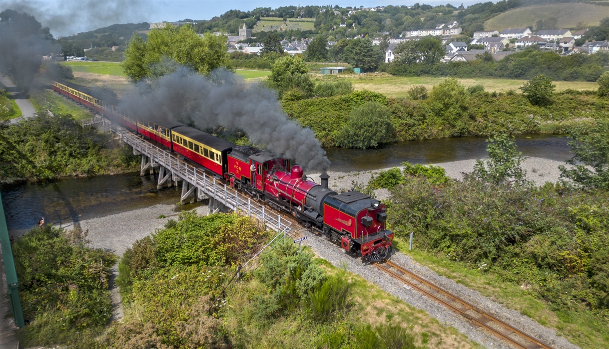 The Garratt locomotive steaming over a timber trestle bridge in Llanbadarn as it departs Aberystwyth.