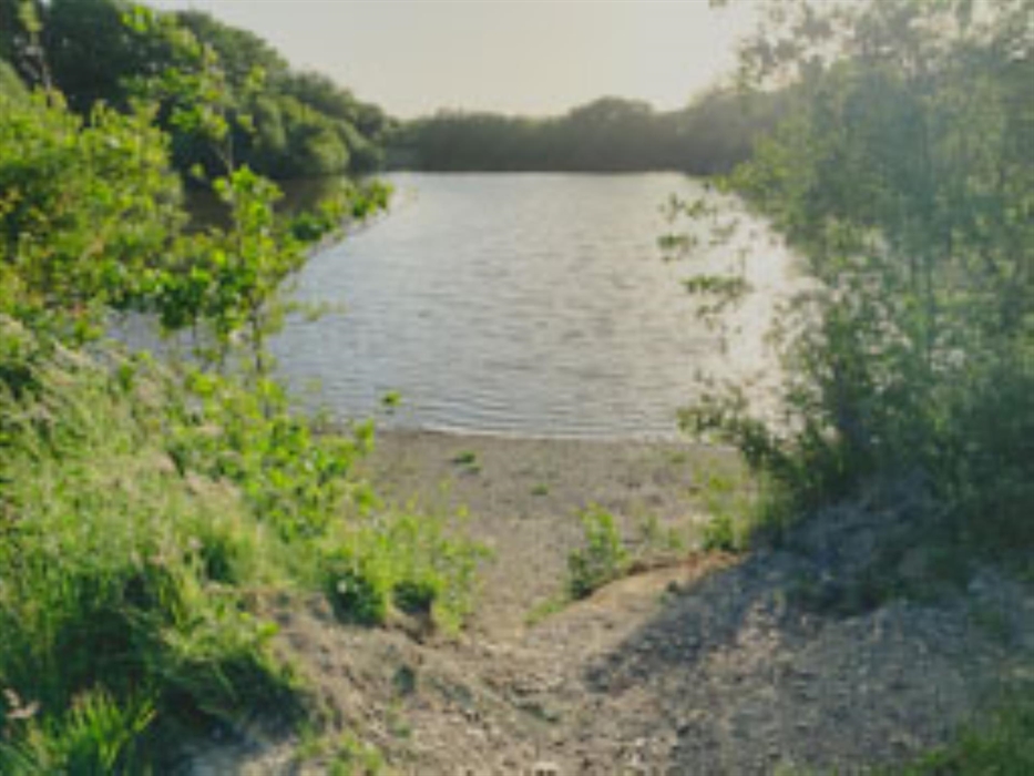 Discover the calm of Timber Hill's private fishing lake, a perfect spot to relax and cast a line amidst nature's chorus