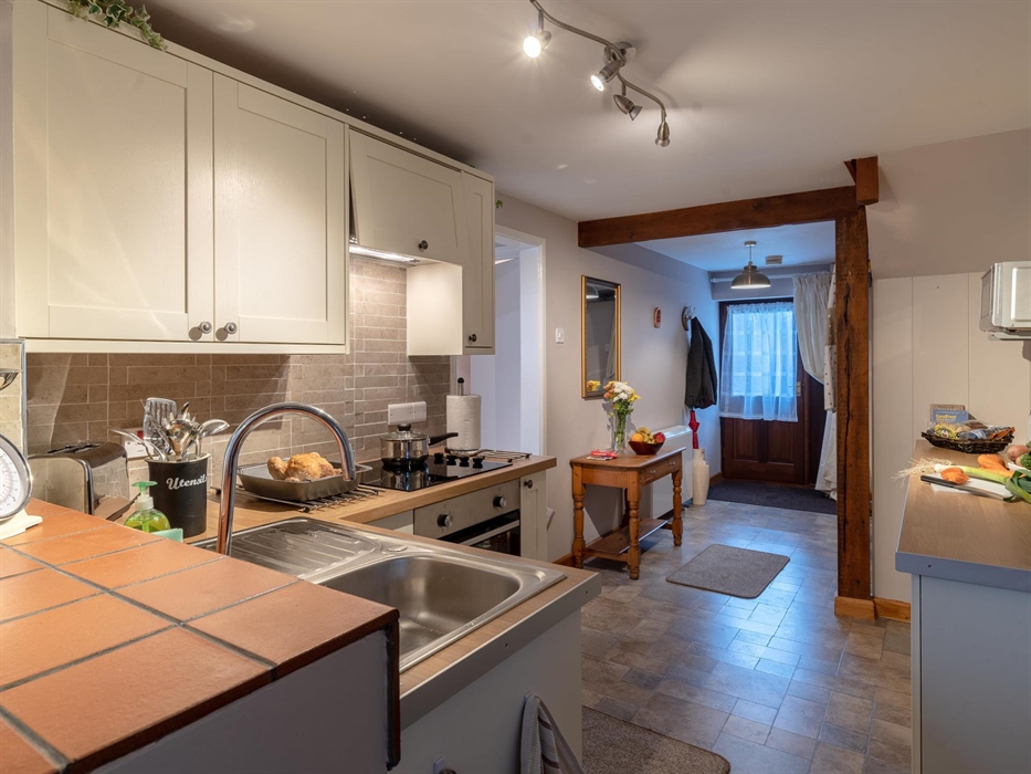 Enter (stairs to the left), through the kitchen to the dining room.  Bathroom and bedroom to the right before you reach the kitchen